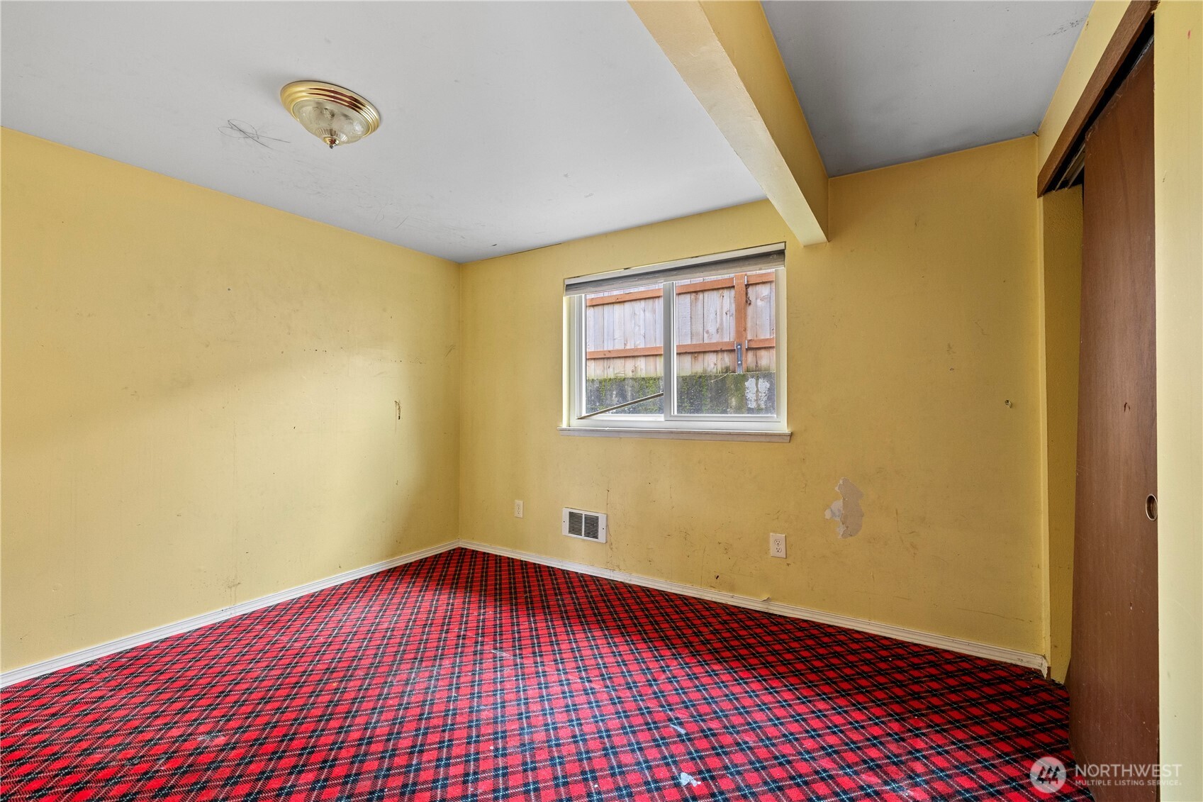 15 76th Street Southwest Everett, WA 98203 - Photo 15 of 39 a view of an empty room with wooden floor and a window