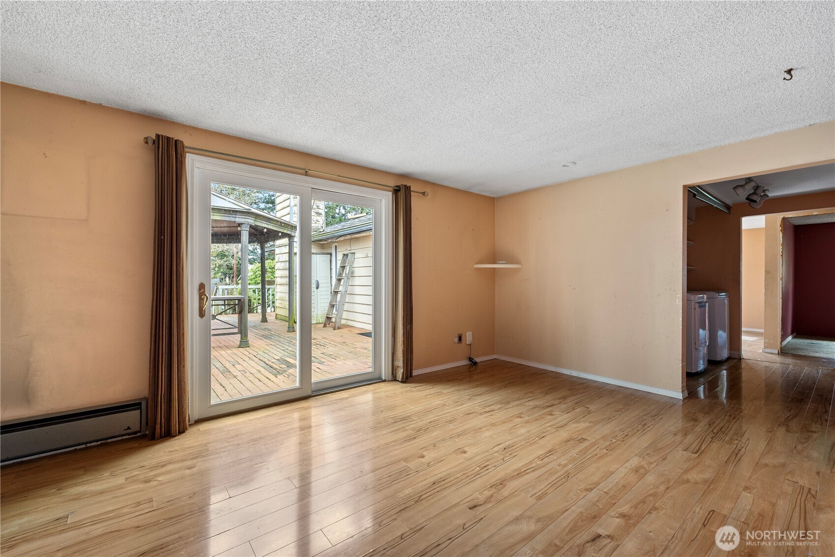 15 76th Street Southwest Everett, WA 98203 - Photo 17 of 39 a view of an empty room with wooden floor and a window