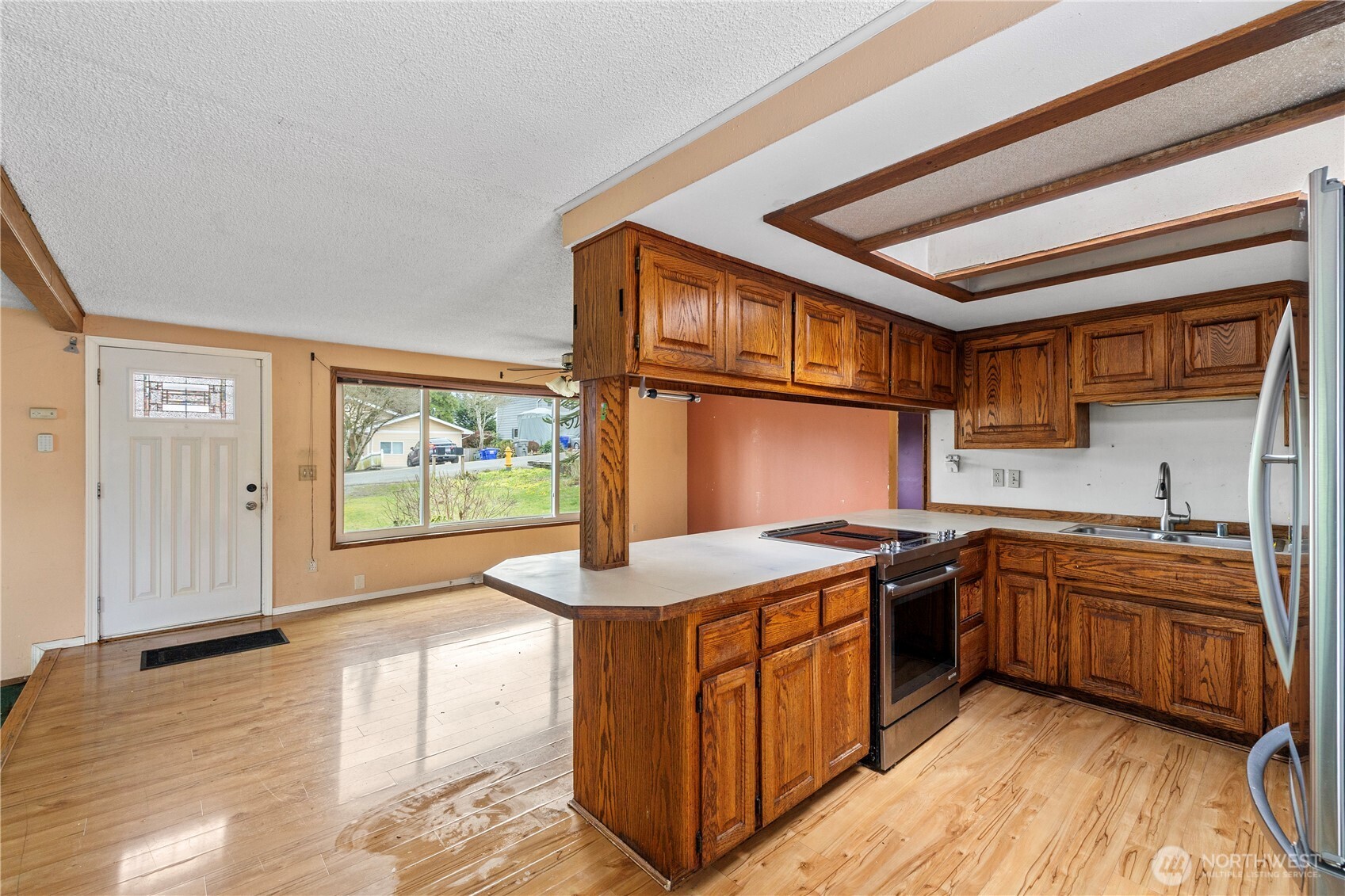 15 76th Street Southwest Everett, WA 98203 - Photo 4 of 39 a kitchen with stainless steel appliances granite countertop a stove a sink and a microwave