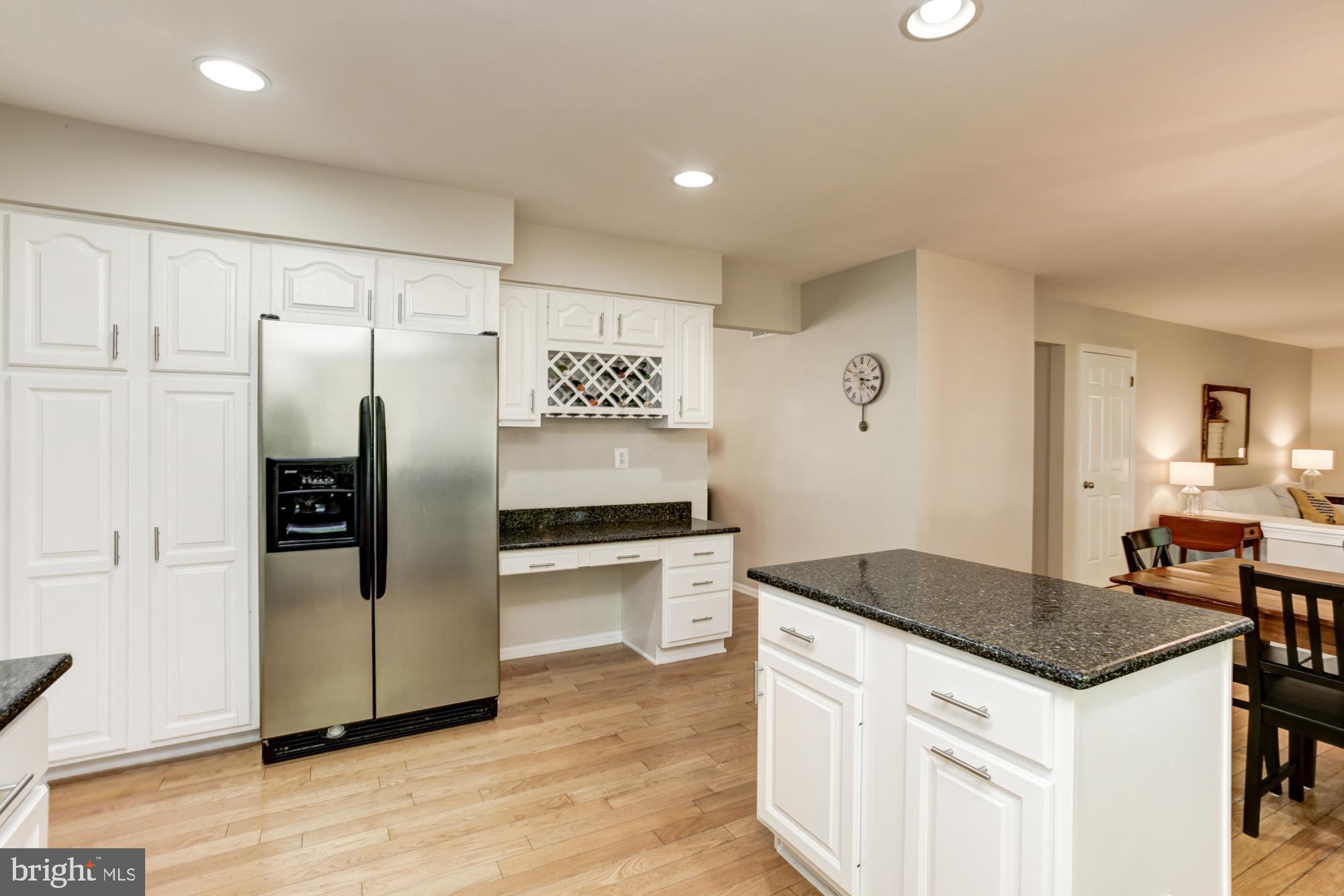 326 Riding Ridge Road Annapolis, MD 21403 - Photo 13 of 63 a kitchen with granite countertop a refrigerator and a stove top oven