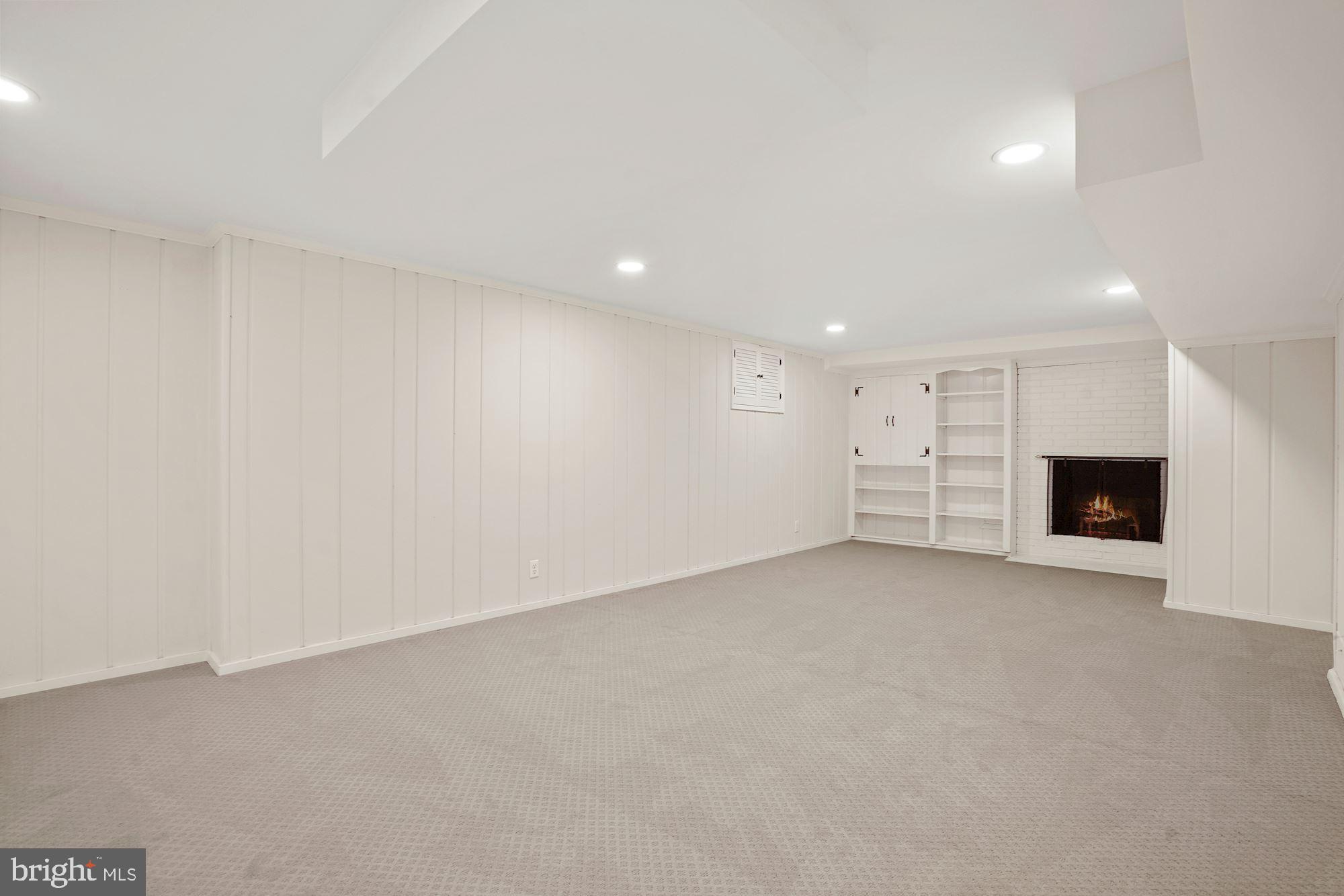 5622 Knollwood Road Bethesda, MD 20816 - Photo 23 of 37 Recreation Room with Fireplace and Storage Cabinet