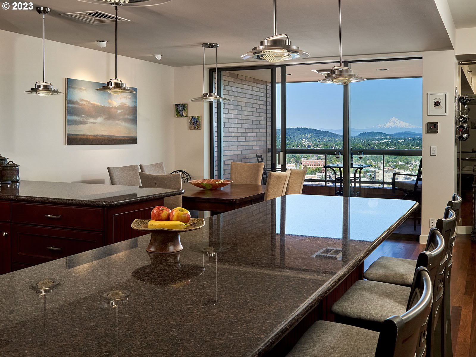 1414 Southwest 3rd Avenue, Unit 2502 Portland, OR 97201 - Photo 13 of 41 a living room with couches a large dining table and with potted plants with wooden floor