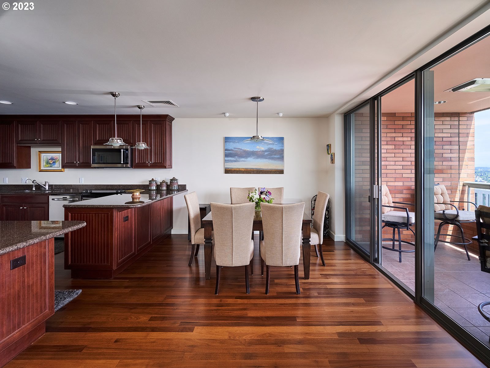 1414 Southwest 3rd Avenue, Unit 2502 Portland, OR 97201 - Photo 6 of 41 a kitchen with stainless steel appliances granite countertop a stove top oven a sink dishwasher a dining table and chairs with wooden floor
