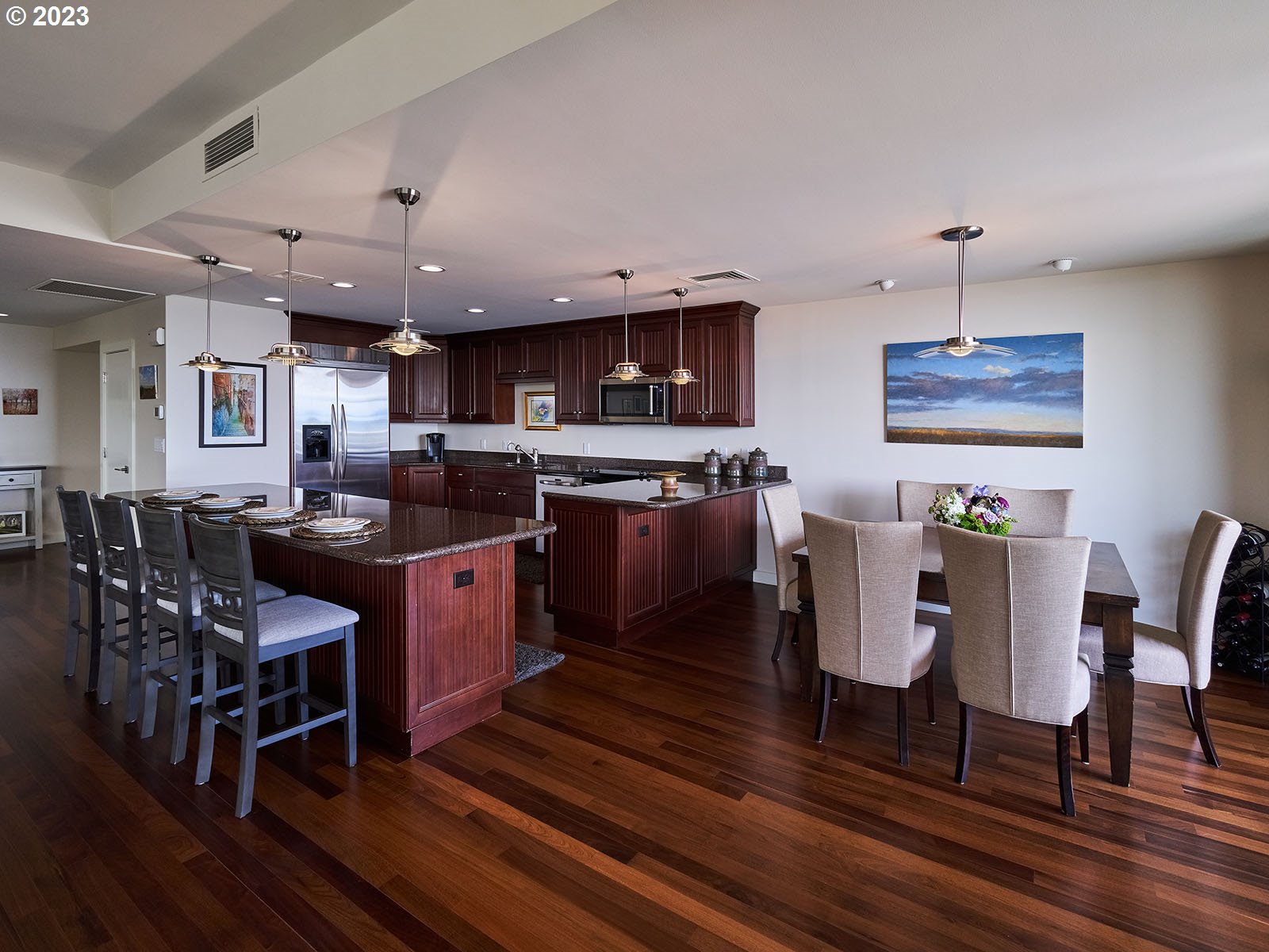 1414 Southwest 3rd Avenue, Unit 2502 Portland, OR 97201 - Photo 7 of 41 a kitchen with stainless steel appliances granite countertop a stove a refrigerator a kitchen island a dining table and chairs