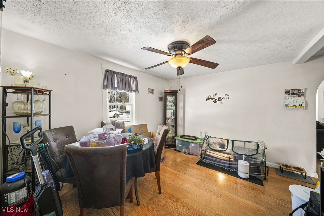 1951 Walton Road Kent, OH 44240 - Photo 8 of 19 Dining area with a ceiling fan, a textured ceiling, and wood finished floors
