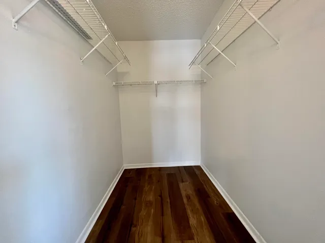 a view of a room with wooden floor