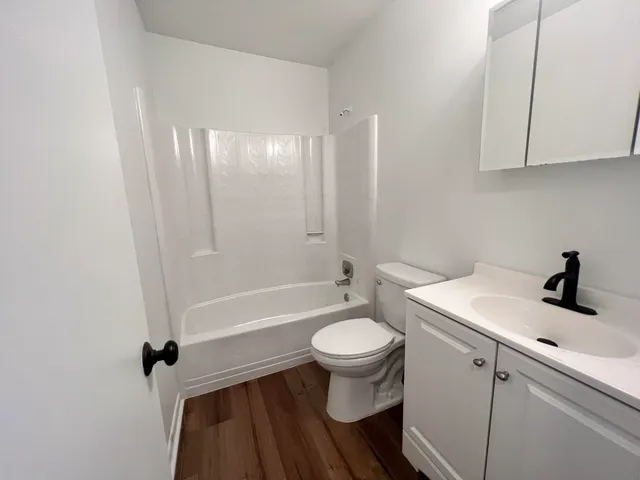 a bathroom with a sink toilet a mirror and shower