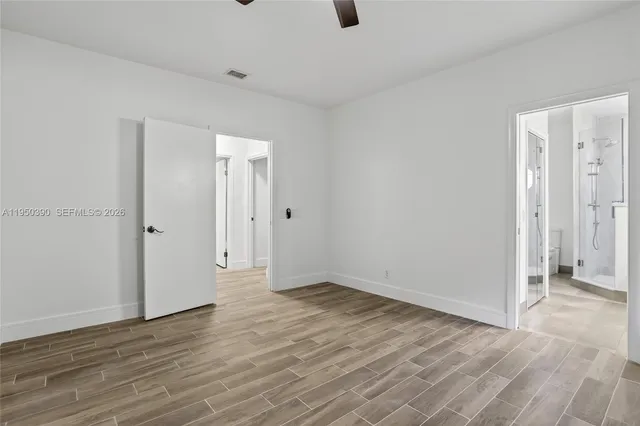 a view of a room with wooden floor