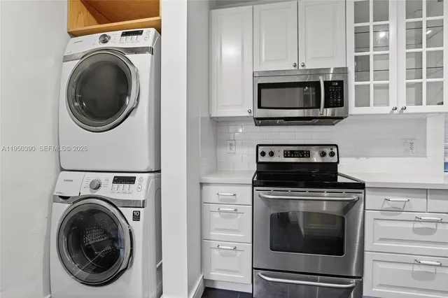 a kitchen with stainless steel appliances granite countertop a sink and a stove