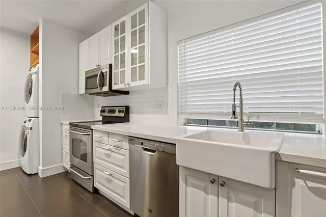 a view of a room with wooden floor and a chandelier