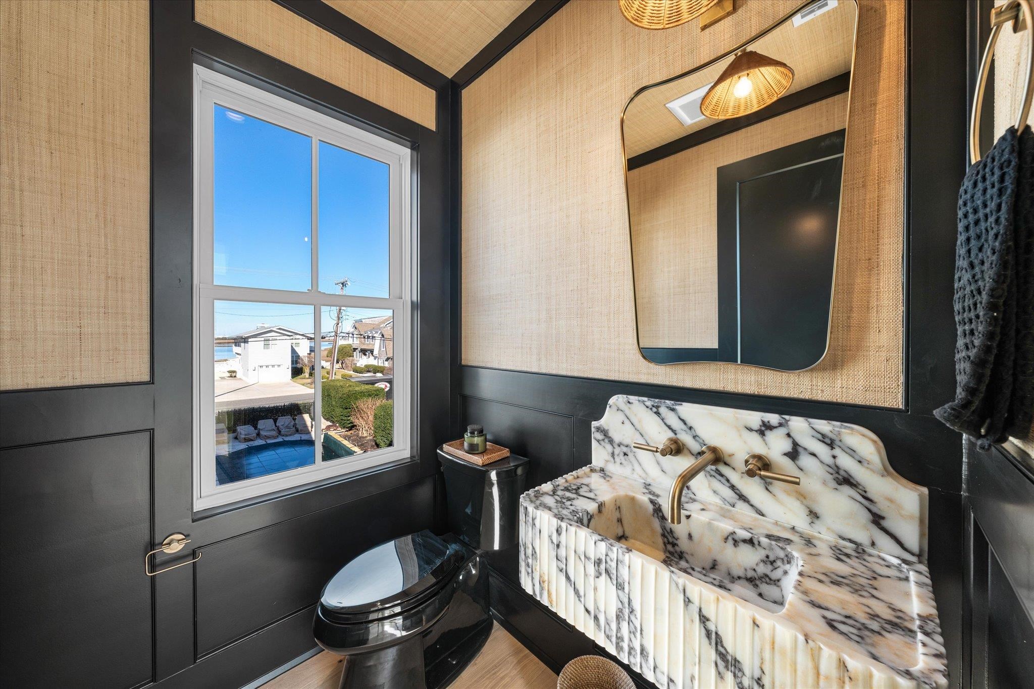 4277 5th Avenue Avalon, NJ 08202 - Photo 17 of 48 a bathroom with a sink and mirror with toilet