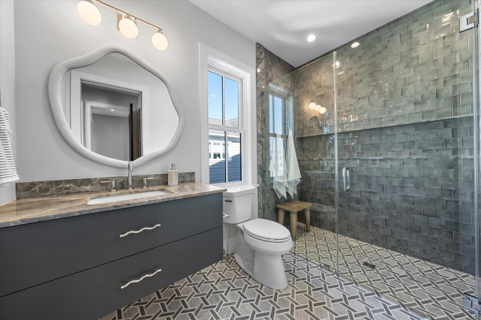 4277 5th Avenue Avalon, NJ 08202 - Photo 21 of 48 a bathroom with a double vanity sink toilet and a mirror