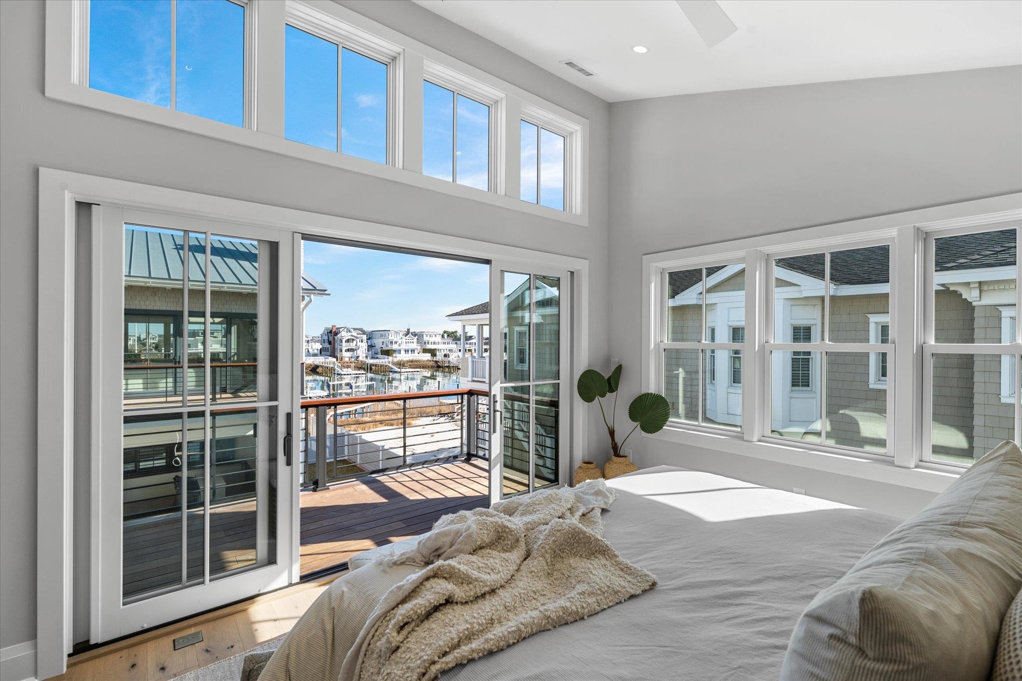 4277 5th Avenue Avalon, NJ 08202 - Photo 22 of 48 a bedroom with a bed and glass window