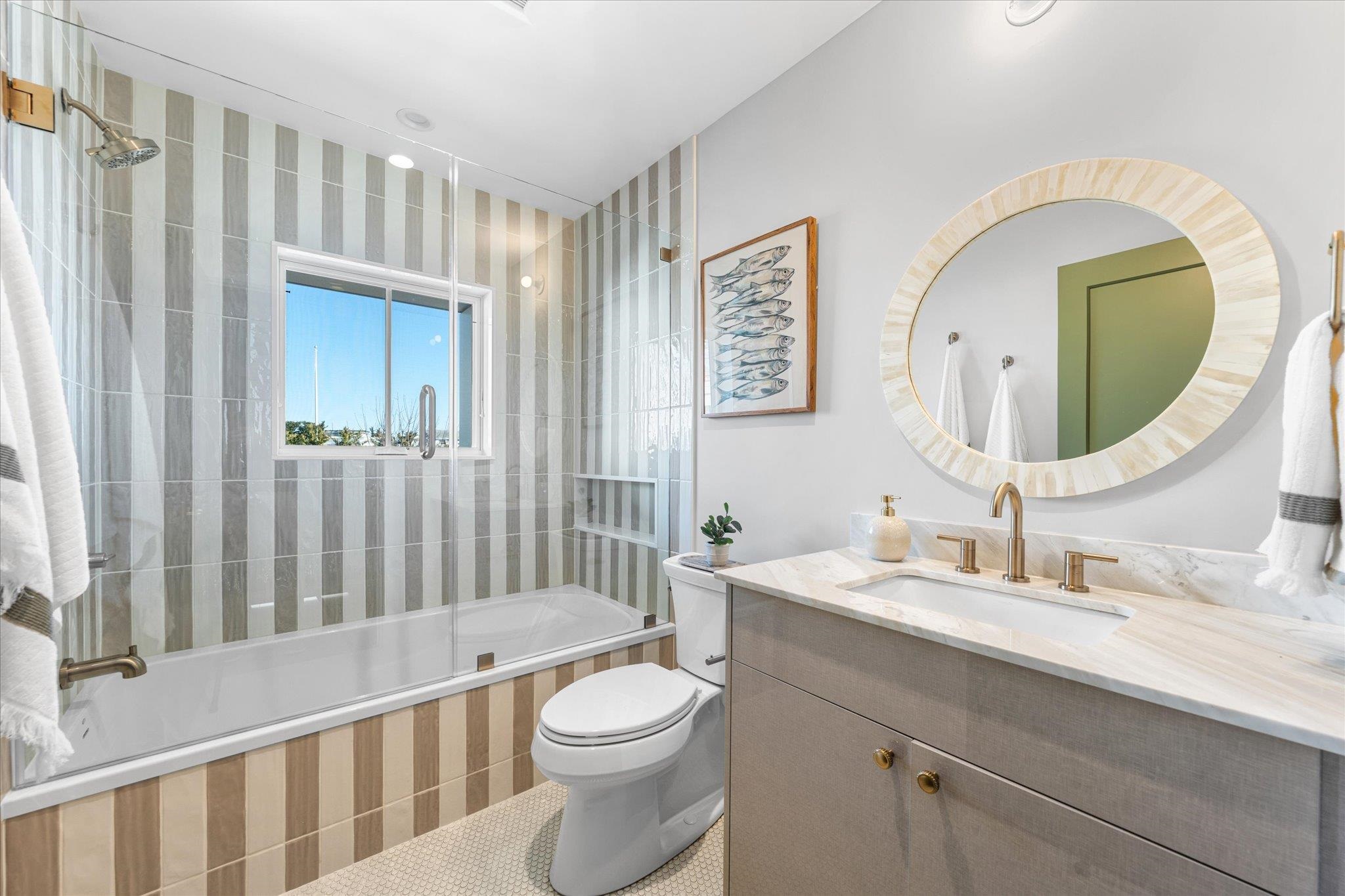 4277 5th Avenue Avalon, NJ 08202 - Photo 38 of 48 a bathroom with a toilet a sink and a mirror