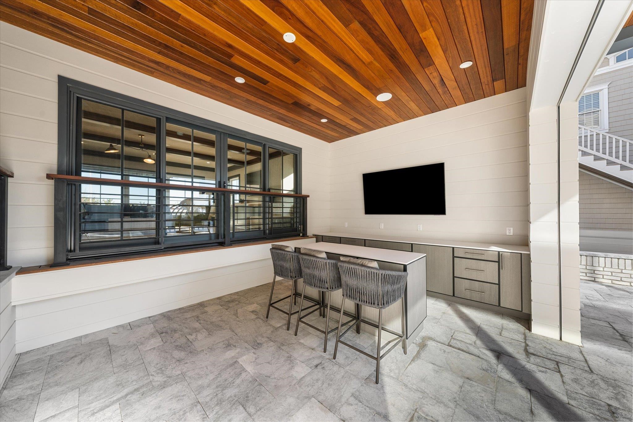 4277 5th Avenue Avalon, NJ 08202 - Photo 40 of 48 a living room with furniture and a flat screen tv