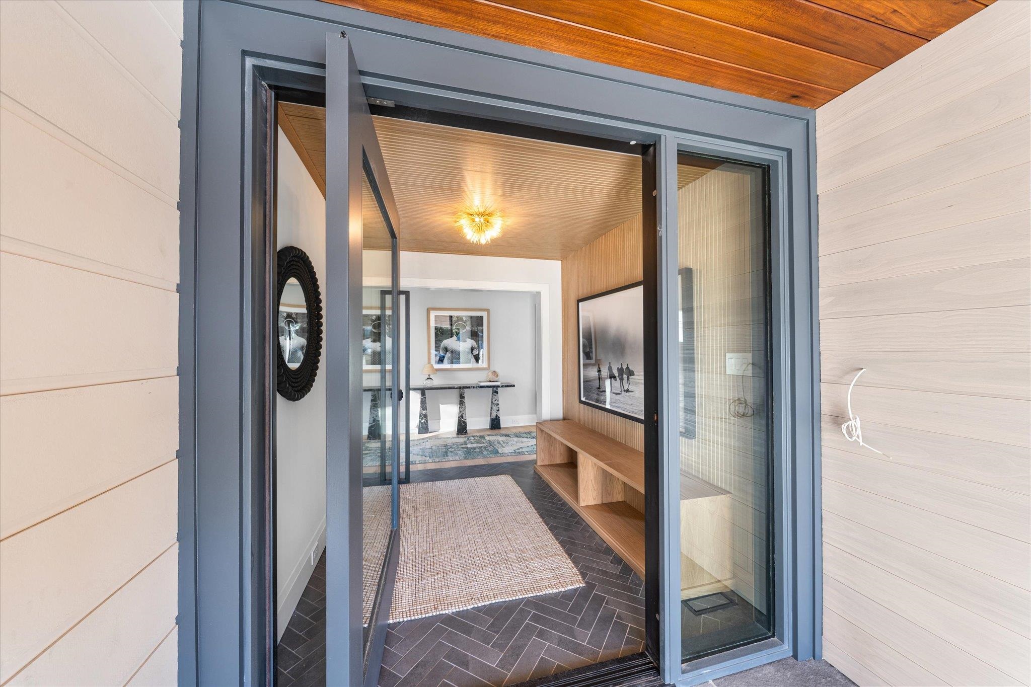 4277 5th Avenue Avalon, NJ 08202 - Photo 4 of 48 hallway view with wooden floor and a glass door