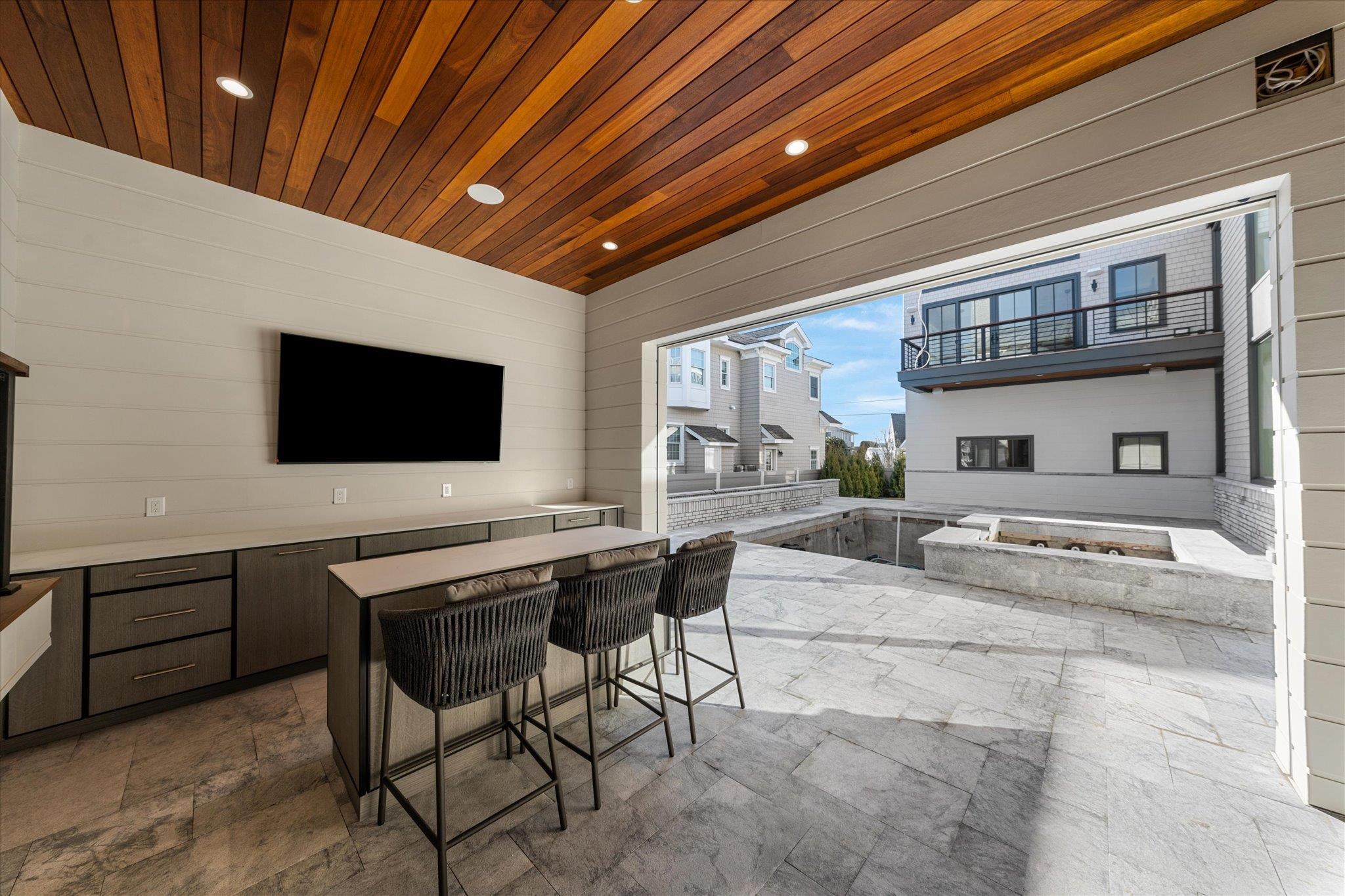 4277 5th Avenue Avalon, NJ 08202 - Photo 42 of 48 a living room with furniture and a flat screen tv
