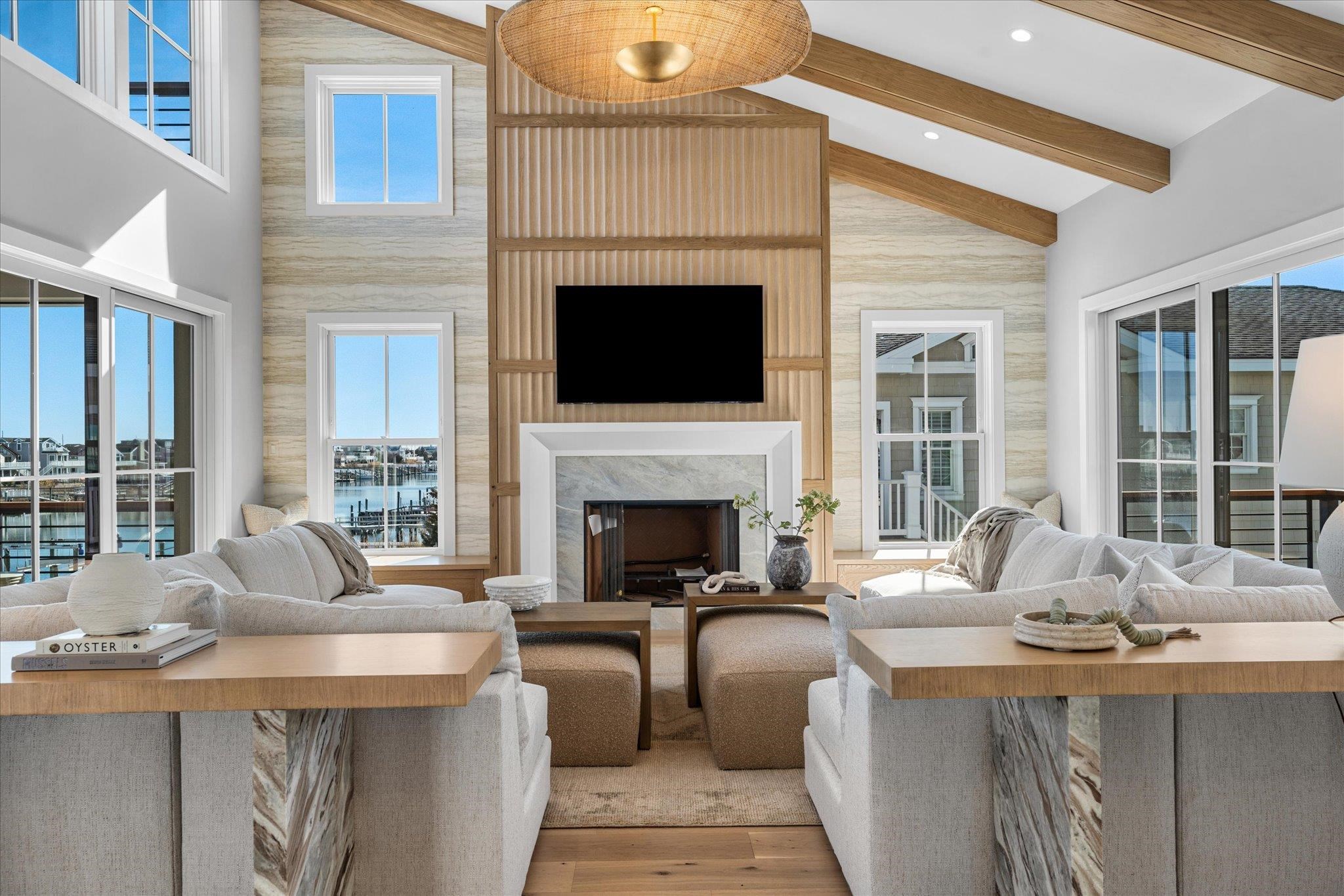 4277 5th Avenue Avalon, NJ 08202 - Photo 5 of 48 a living room with furniture a fireplace and windows