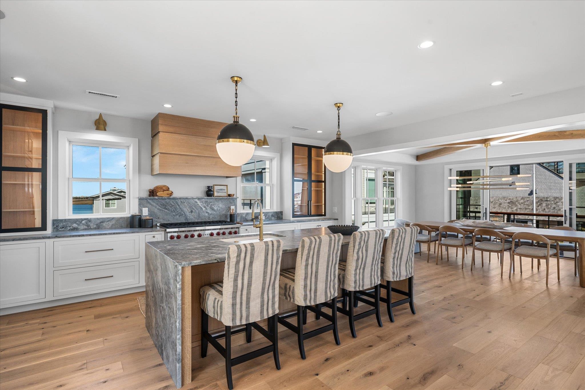 4277 5th Avenue Avalon, NJ 08202 - Photo 9 of 48 a kitchen with stainless steel appliances a dining table chairs and wooden floor