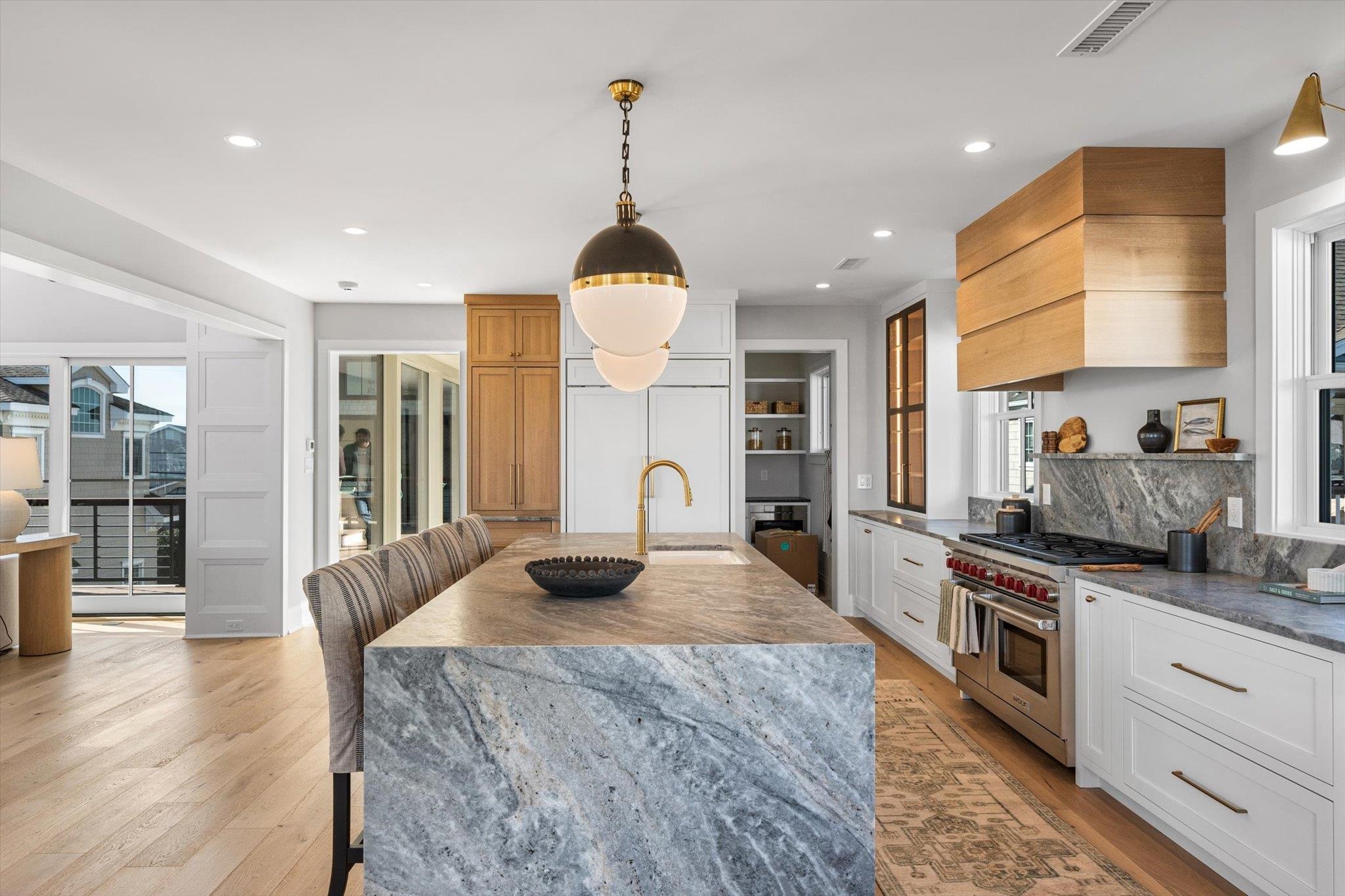 4277 5th Avenue Avalon, NJ 08202 - Photo 10 of 48 a kitchen with stainless steel appliances granite countertop a sink a stove and a wooden floors