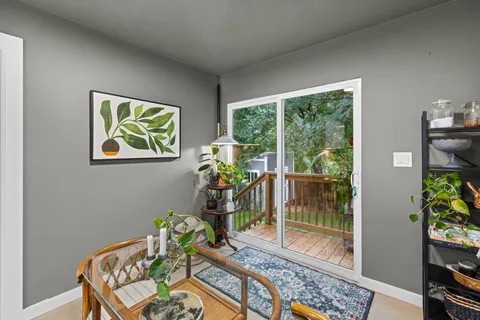 a dining room with furniture and a potted plant