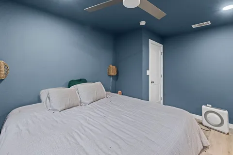 a bedroom with a bed and a lamp