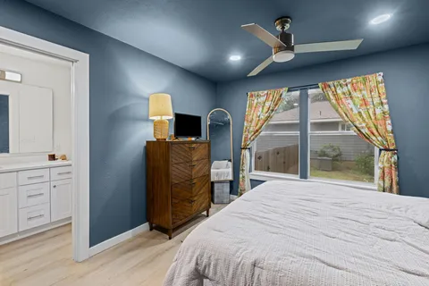 a bedroom with a bed and a large window