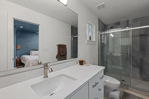 a bathroom with a sink toilet and shower
