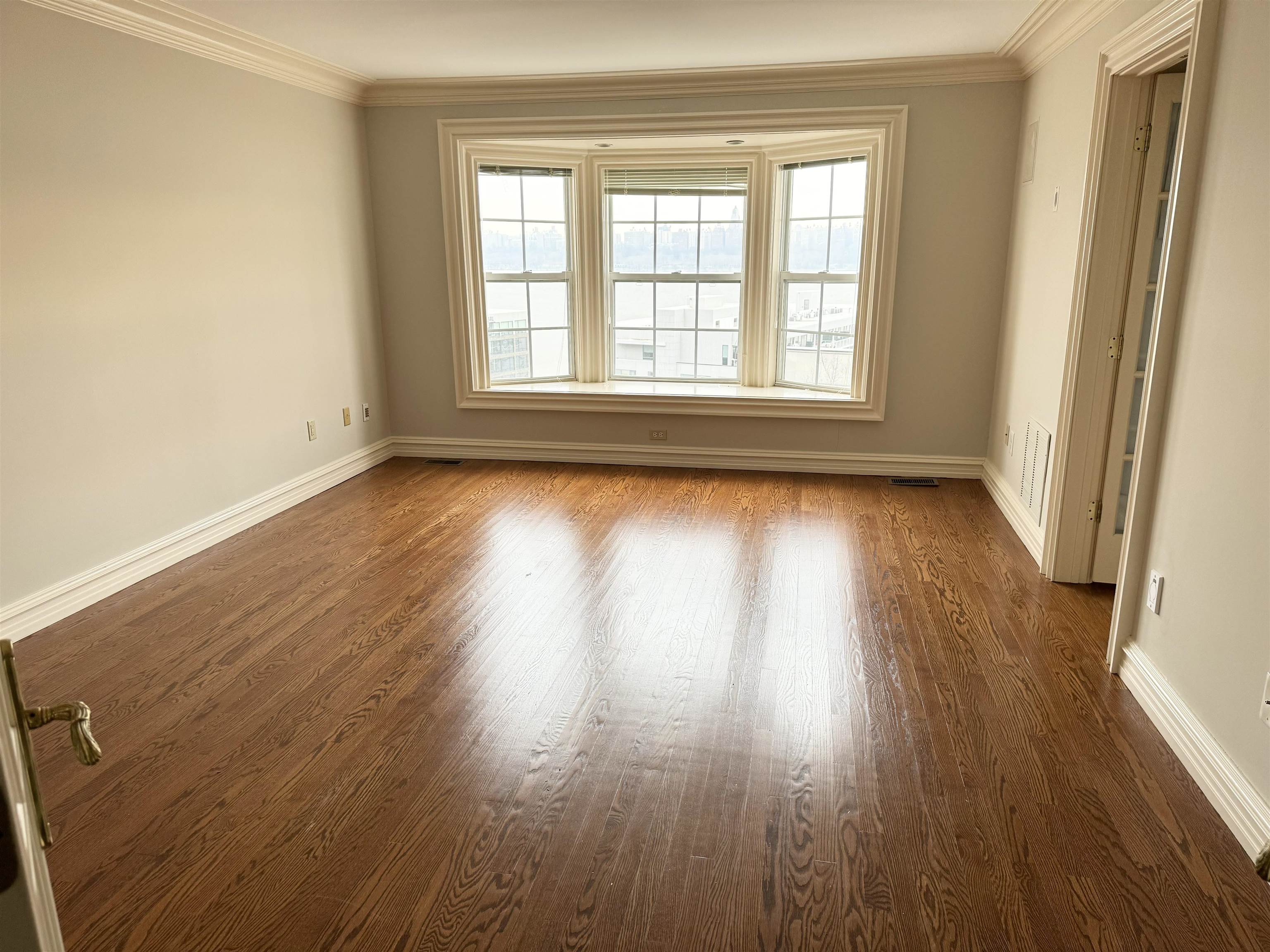 54 Bergen Ridge Road, Unit 1 North Bergen, NJ 07047 - Photo 11 of 16 an empty room with wooden floor and windows