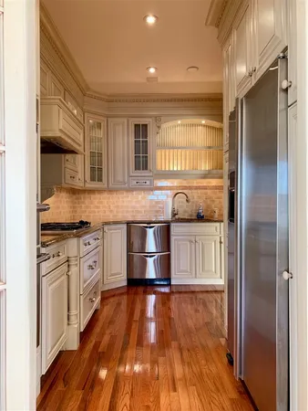 a kitchen with stainless steel appliances granite countertop a stove and a refrigerator