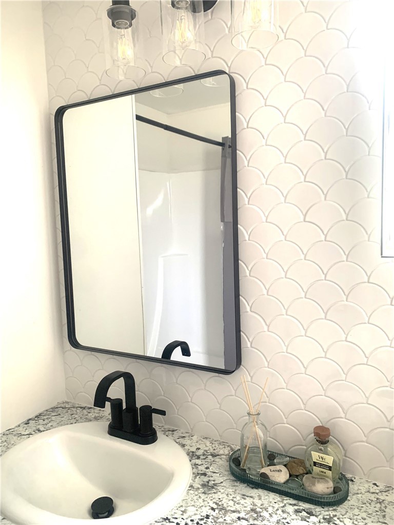 975 California Street, Unit 72 Calimesa, CA 92320 - Photo 21 of 23 a bathroom with a sink and a mirror