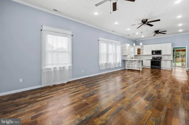 an empty room with windows and natural light