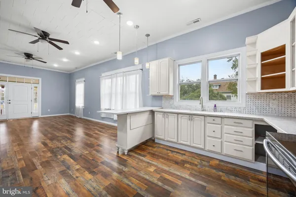 a view of entryway and hall with wooden floor