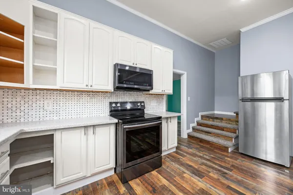 a view of a room with wooden floor and a window