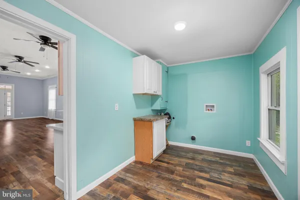 an empty room with window and wooden floor