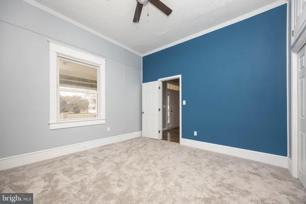 a view of a livingroom with wooden floor & entryway
