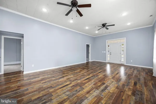 a view of kitchen and hall with wooden floor