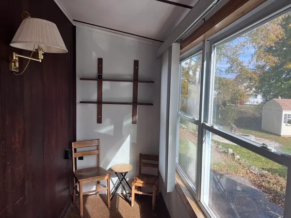 a view of a room with wooden floor and windows