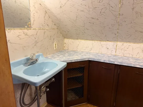 a bathroom with a sink vanity and a mirror