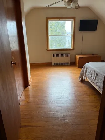 a view of a livingroom with wooden floor and windows