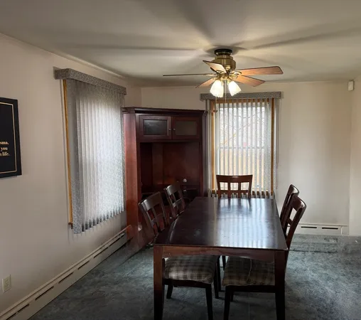 a dining room with furniture and window
