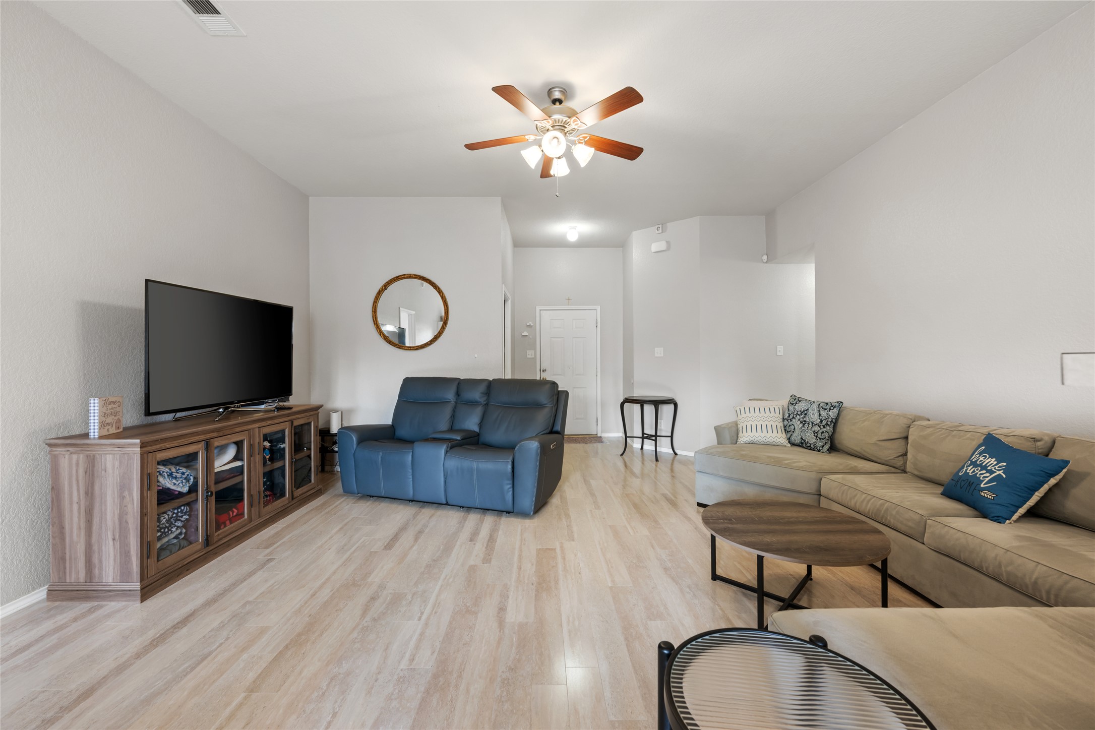 144 Calcite Lane Jarrell, TX 76537 - Photo 9 of 38 Luminous living area features wide plank flooring and a classic ceiling fan for ultimate comfort.