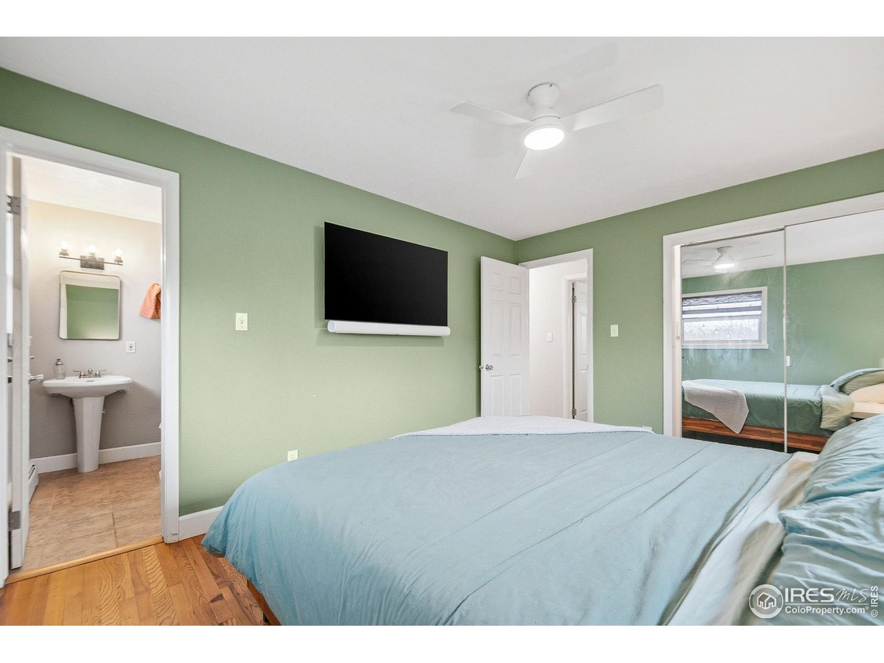 6034 South Steele Street Centennial, CO 80121 - Photo 14 of 46 a bedroom with a bed and a flat screen tv