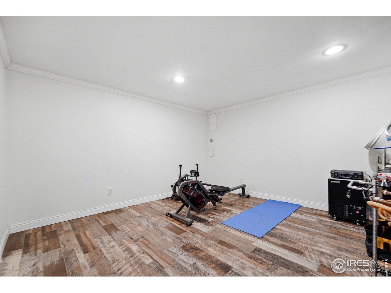 6034 South Steele Street Centennial, CO 80121 - Photo 23 of 46 a room with wooden floor and furniture