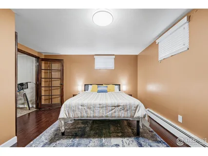 a bedroom with a bed and a large mirror