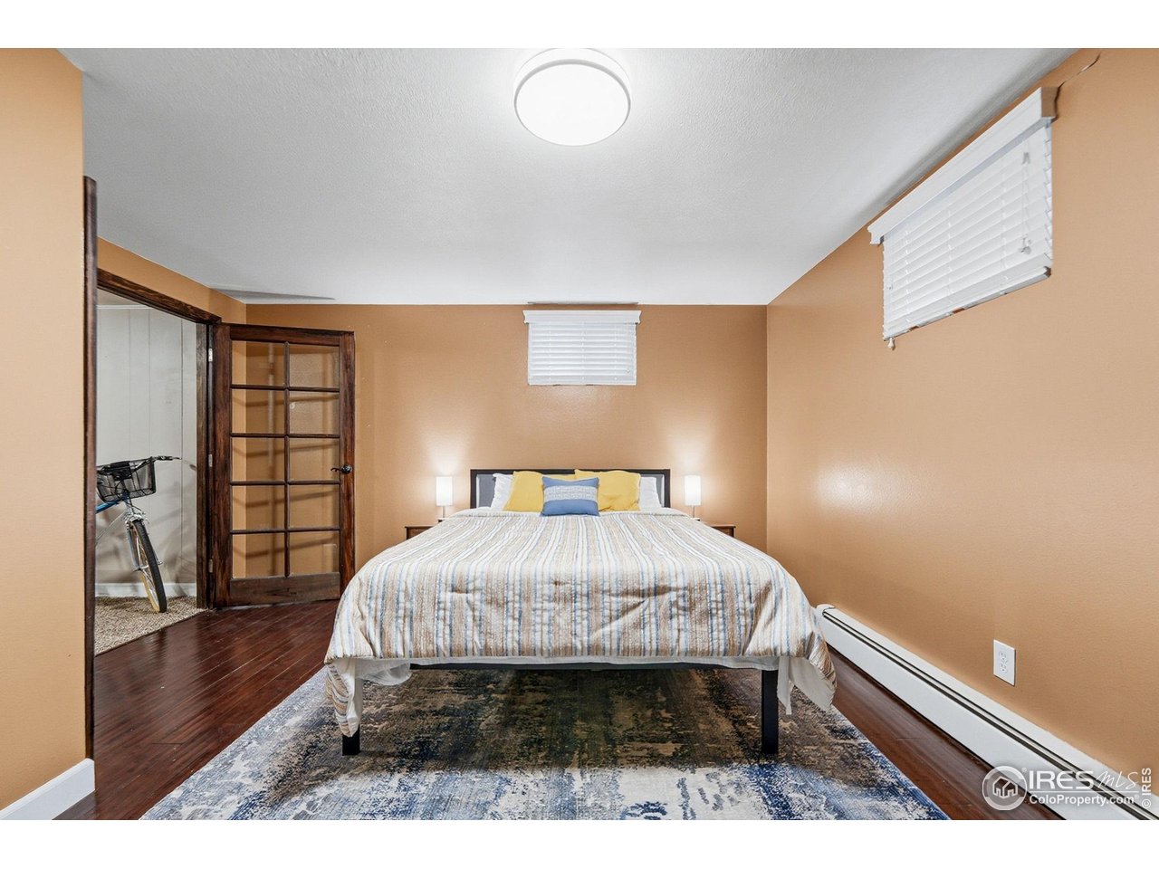 6034 South Steele Street Centennial, CO 80121 - Photo 27 of 46 a bed sitting in a bedroom next to a window