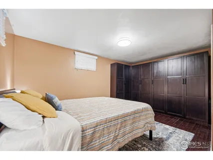 a bedroom with a bed and a large mirror