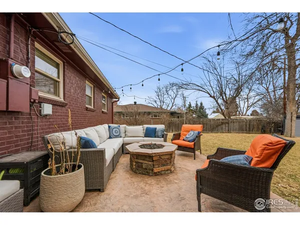 a swimming pool with yard and tree in front of it