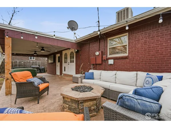 a view of a house with backyard sitting area and garden