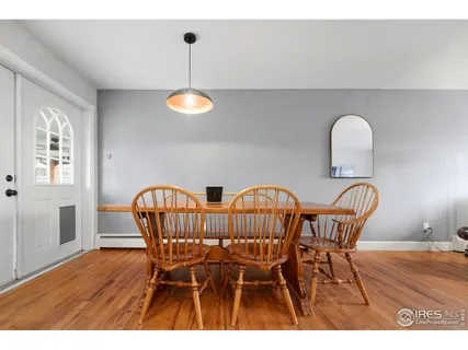a kitchen with stainless steel appliances granite countertop a sink dishwasher and white cabinets with wooden floor
